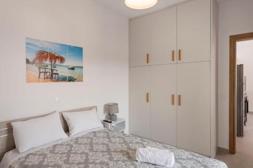 a bedroom with a bed and a white cabinet at Cycladic Sunlight 2bedroom House in Krotiri