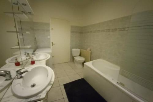 ein Badezimmer mit einem Waschbecken, einer Badewanne und einem WC in der Unterkunft Beau logement proche plage et centre-ville in La Tranche-sur-Mer
