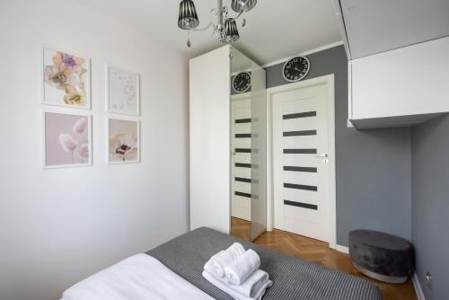 a small bedroom with a bed and a door at Wola Okopowa Luxury Apartment in Warsaw