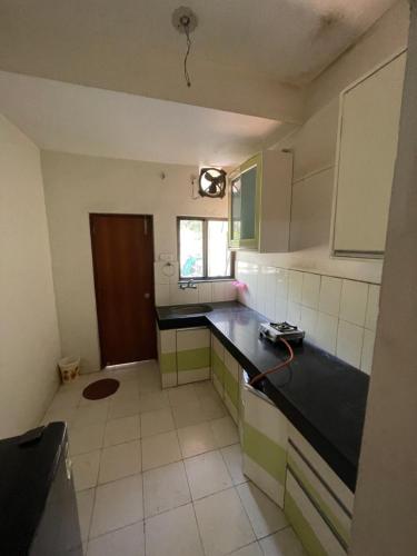a kitchen with a black counter top in a room at Samruddhi S3 homestay garden villa or S1 in Nagpur