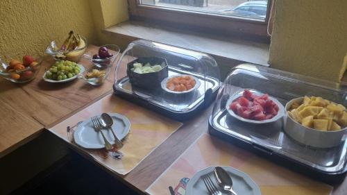 a table topped with trays of food on a table at Hotel Schweizer Hof in Halle an der Saale
