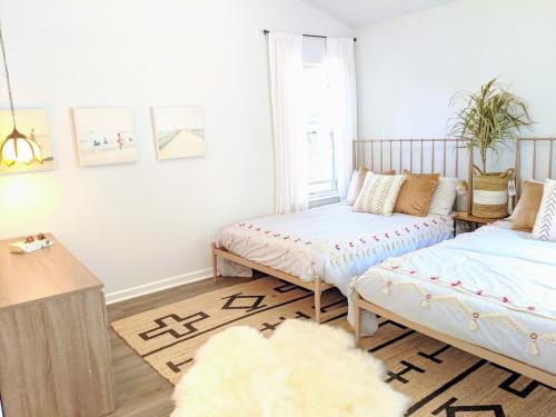 a bedroom with two beds and a rug at RARE Downtown Matthews walk 2 shops restauraunts hike CLT 2 Bedroom not 3br in Charlotte