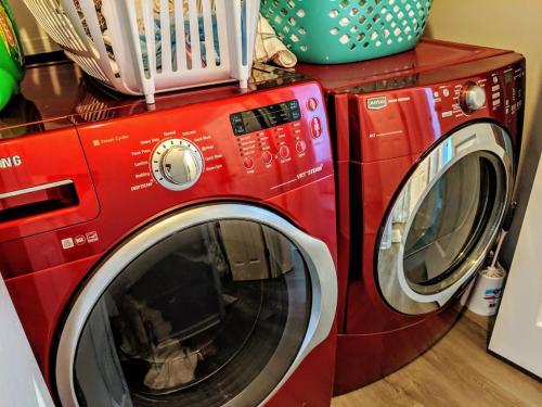 two red washing machines sitting next to each other at RARE Downtown Matthews walk 2 shops restauraunts hike CLT 2 Bedroom not 3br in Charlotte
