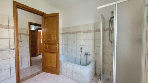 a bathroom with a bath tub and a shower at Mara's Home Holiday in Orosei