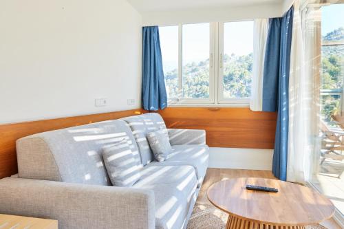 a living room with a couch and a table at Los Geranios in Port de Soller