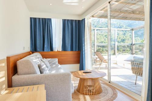 a living room with a couch and a table at Los Geranios in Port de Soller