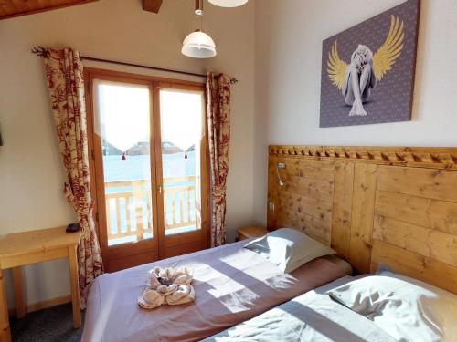 a bedroom with a bed with an angel picture on the wall at Chalet Avoriaz, 8 pièces, 14 personnes - FR-1-314-101 in Avoriaz