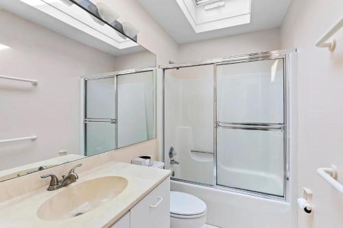 a bathroom with a shower and a sink and a toilet at Rosemorran Retreat in Sag Harbor