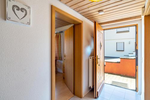 a hallway with a door leading to a balcony at Haus Erlenmaier in Schömberg