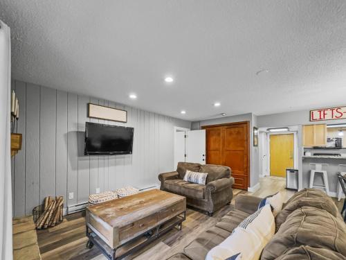 a living room with a couch and a flat screen tv at CM325 Copper Mtn Inn condo in Copper Mountain