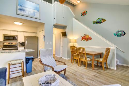 a kitchen and living room with a table and chairs at half Mi to Maryland Beach Family Condo with Balcony in Ocean City
