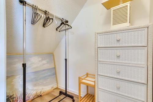 a bedroom with a dresser and a closet at half Mi to Maryland Beach Family Condo with Balcony in Ocean City
