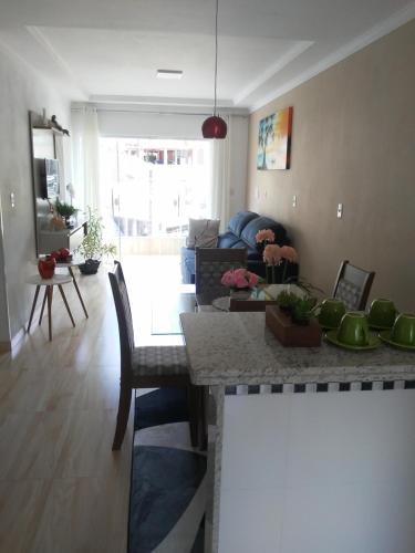 a kitchen and living room with a table and a couch at QUARTO CASA FREDERICO in Domingos Martins