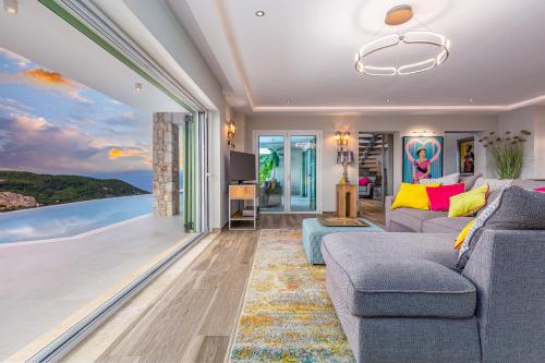 a living room with a view of the ocean at Villa Nirvana in Áyioi Dhéka