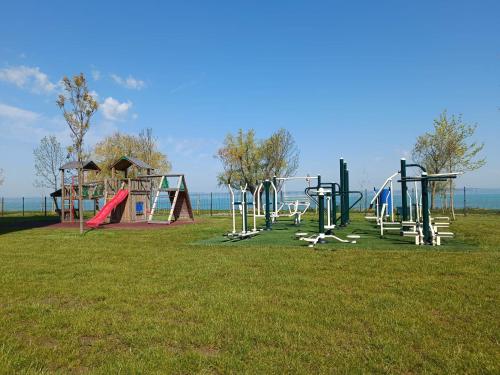 a park with a playground with slides and swings at Bala Beach Siófok Apartman in Siófok