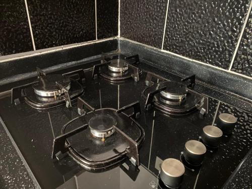 a stove top with four pots on top of it at palmiye butik otel in Mezitli