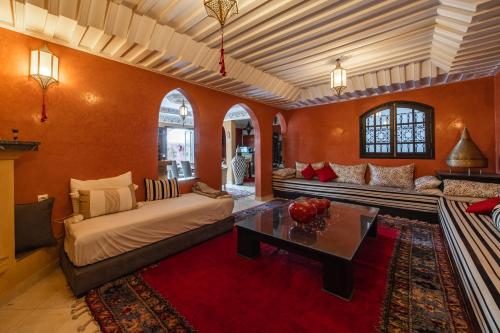 a living room with a couch and a table at Riad Appart Arwa in Marrakech