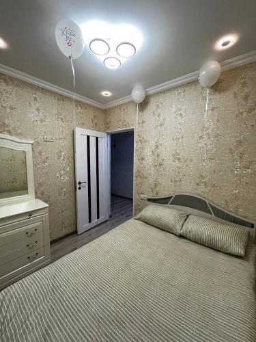 a bedroom with a large bed and a television at Central Charm Guesthouse in Gyumri