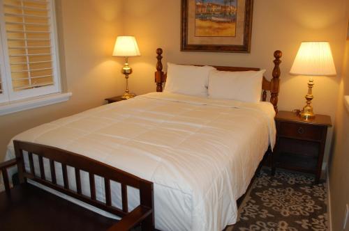 a bedroom with a large white bed with two lamps at Destin West Villa Gulfside V406 in Fort Walton Beach