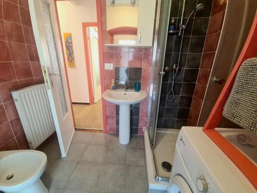 a bathroom with a sink and a toilet and a shower at Rosa Tramonto Portofino by PortofinoVacanze in Rapallo