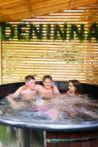 a group of three people in a hot tub at Hotel & Spa DENINNA in Vinnytsya