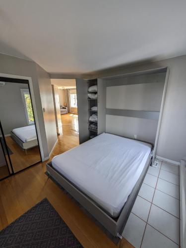 a bedroom with a large bed and a mirror at Le Cocon du Rivage in Roberval