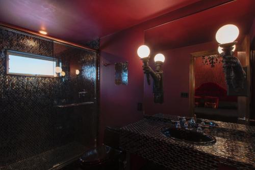 a bathroom with a shower and a sink and a mirror at The Roxbury in Roxbury