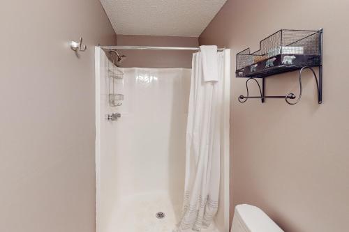 a bathroom with a shower with a white shower curtain at Glorious Scenery in Dover