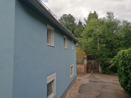 a blue house with windows on the side of it at Zum Pfarrberg in Meerane