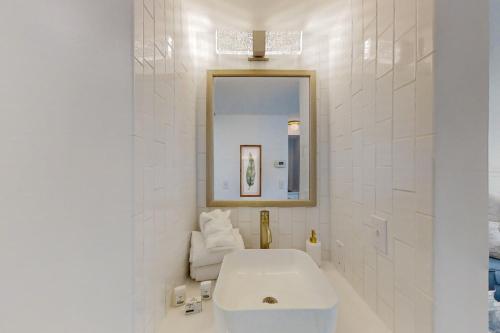 a white bathroom with a sink and a mirror at Renaissance 1009 in Myrtle Beach