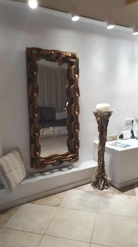 a mirror on a wall next to a sink at AQUA VILLA in Selínia