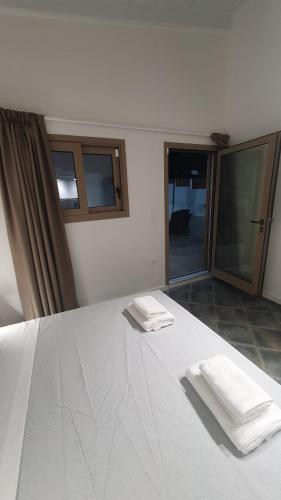 a bedroom with a bed with two towels on it at AQUA VILLA in Selínia