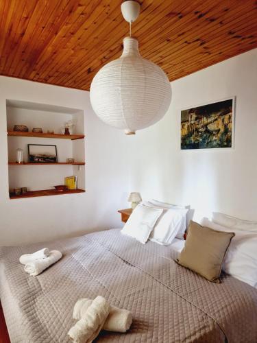 a bedroom with a large bed with a large ceiling at Apartment Monte Rosa in Mali Lošinj
