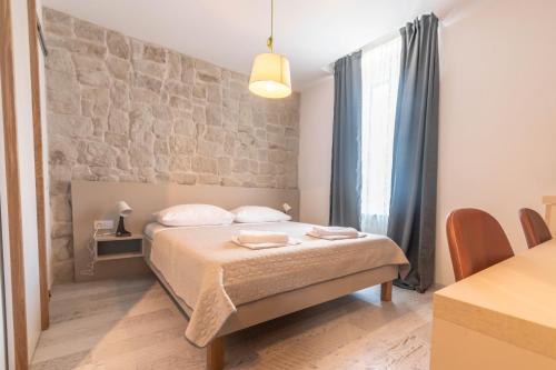 Postel nebo postele na pokoji v ubytování L&B City Center Studios Apartments