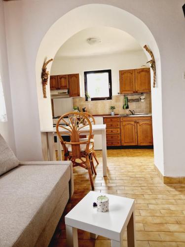 a living room with a couch and a table at Apartment Monte Rosa in Mali Lošinj