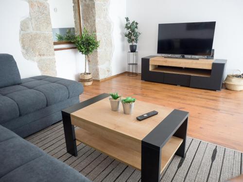 a living room with a tv and a coffee table at Holiday Home Vera in Malinska