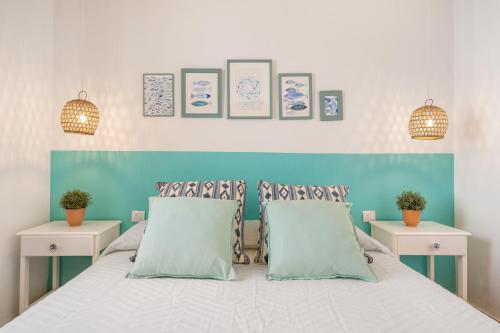 a bedroom with a bed with two tables and two pillows at Sa Salada in Son Carrio
