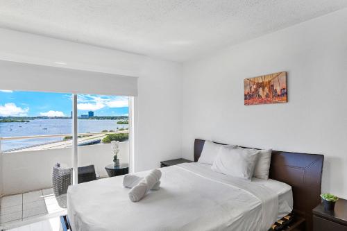 a bedroom with a bed and a view of the ocean at Breath-taking views from this cozy studio in Miami Beach