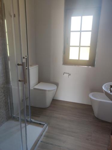 a bathroom with a toilet and a sink at Casa Velay in Fisterra
