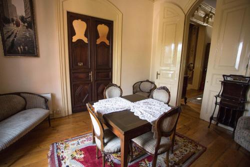 a dining room with a table and chairs and a door at Büyükada Anastasia Meziki History Mansion in Buyukada