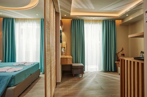 a hotel room with a bed and a window at Iniohos Zante Hotel & Suites in Argasi
