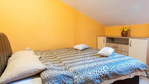 a bedroom with a bed with yellow walls at Nature View Cozy Flat 1 min to Sea in Kotor in Tivat