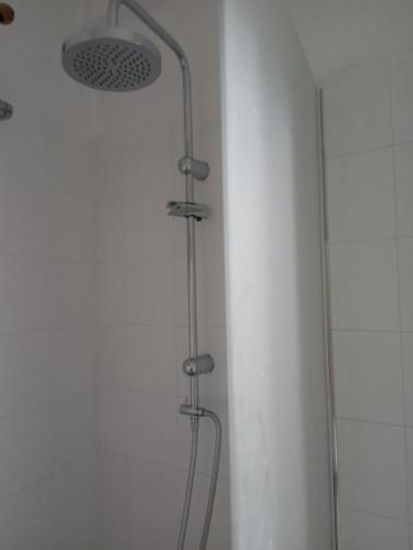 a shower with a shower head in a bathroom at Valta's Room 4 in Paleros