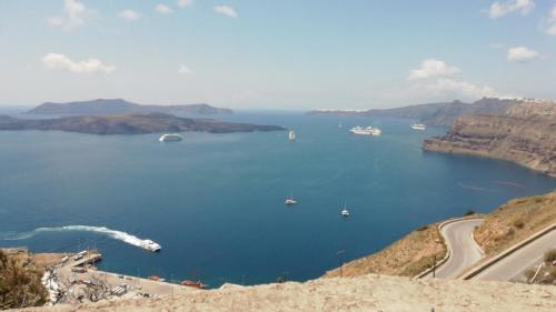 a view of a large body of water with boats in it at Poudras Amazing View Caldera in Órmos Athiniós