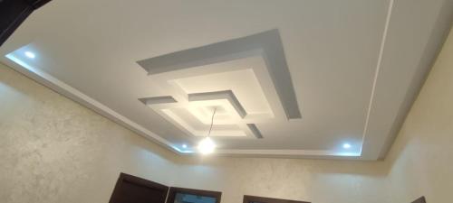 a ceiling with a light in a room at Nador New in Nador