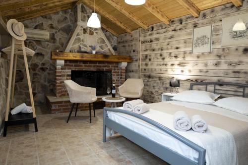 a bedroom with two beds and a fireplace at M&T in Supetar