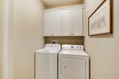 a white laundry room with a washer and dryer at Charming Starkville Vacation Rental about 5 Mi to MSU! in Starkville