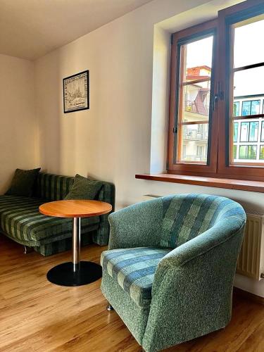 a living room with a couch and a table at Willa Julia in Karwia
