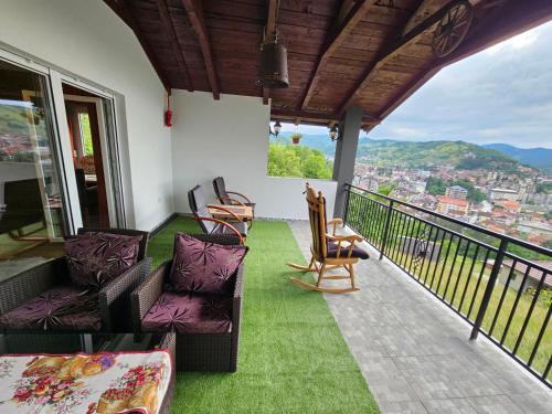 a balcony with chairs and a view of a city at City View House in Bijelo Polje