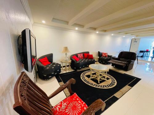 a living room with couches and a tv at Misty Mountain in Murree